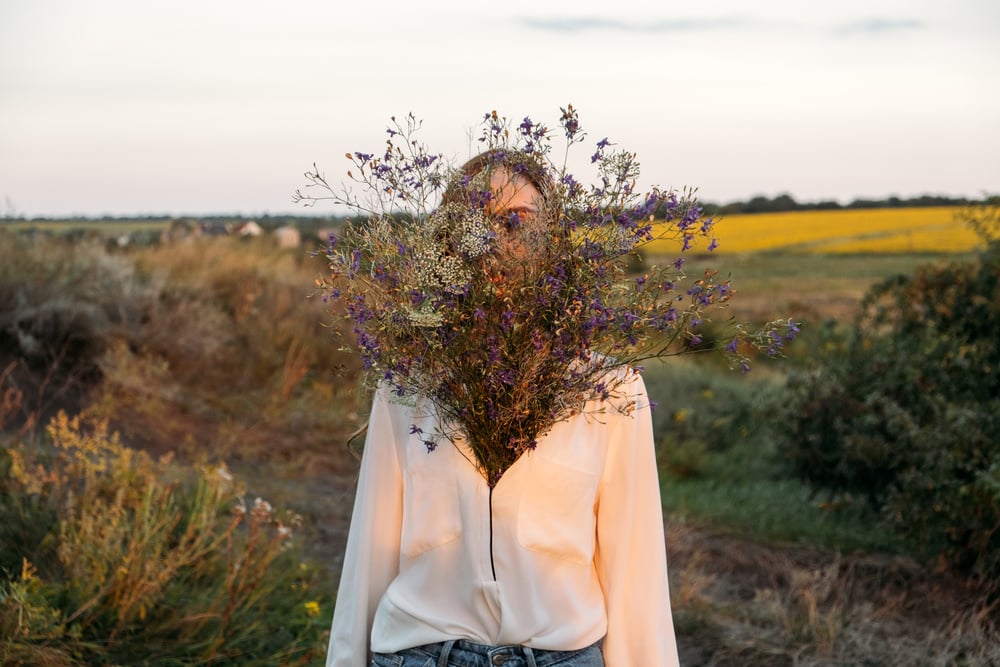 Celebration of Self, Inner Beauty, Self-Love, Self-Soothing, Self-Celebration. Happy Young Girl Holding Wildflowers Bouquet, Relaxing and Enjoying Life