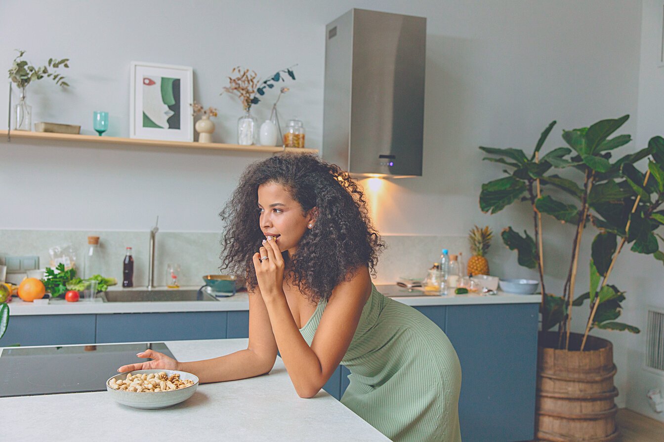 Woman in Green Shirt Sitting at the Table